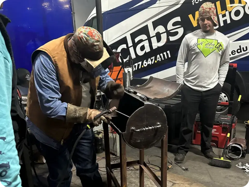 Welding student at a career school workbench
